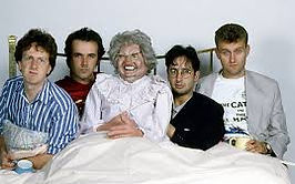 Mary whitehouse Experience cast in bed with a puppet of Mary Whitehouse